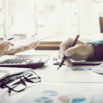 A student studying on a laptop with a bright, modern background, representing online business administration education